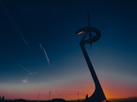 a statue of a wind turbine in the middle of a field
